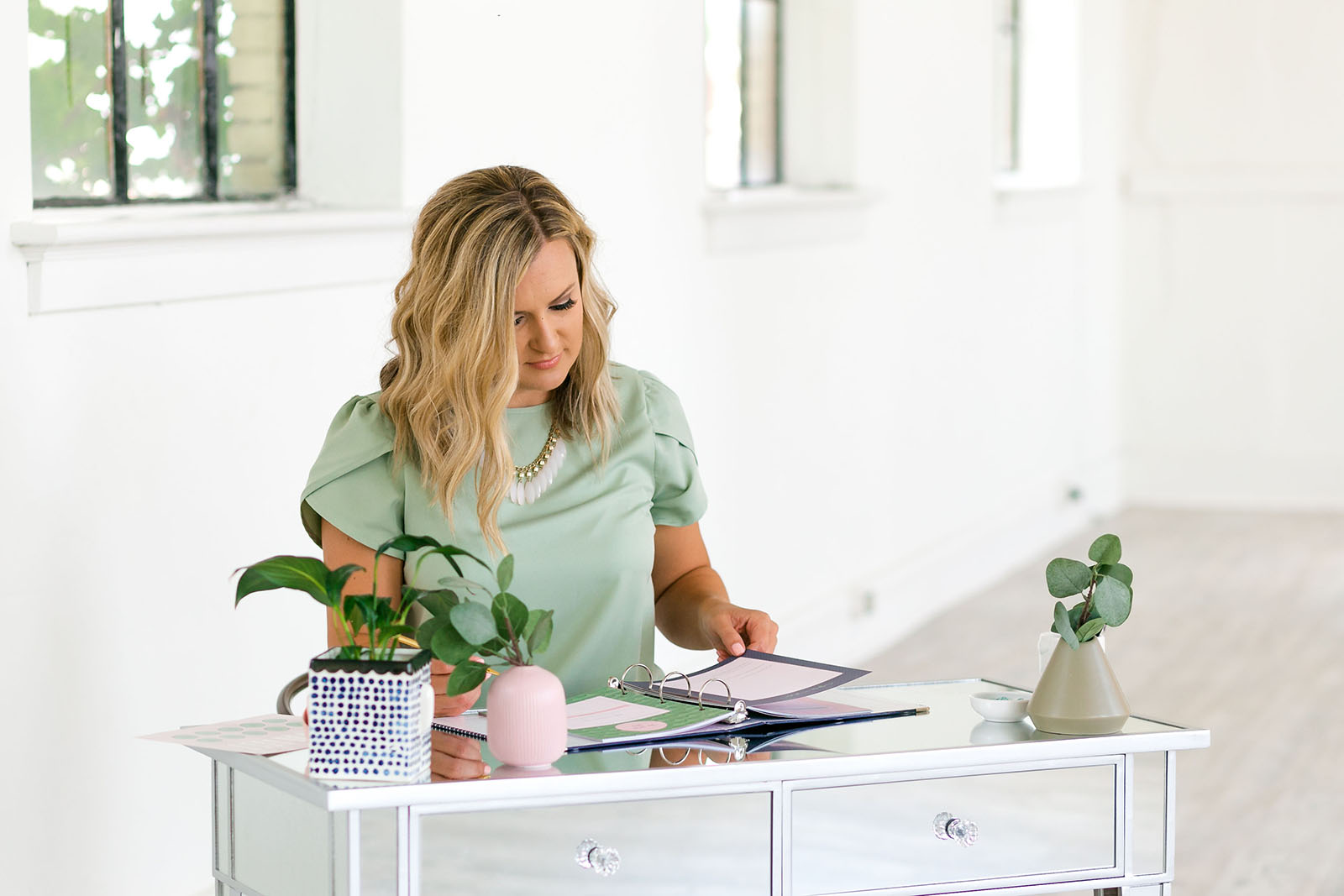 Woman photographer at her desk, determine photography pricing