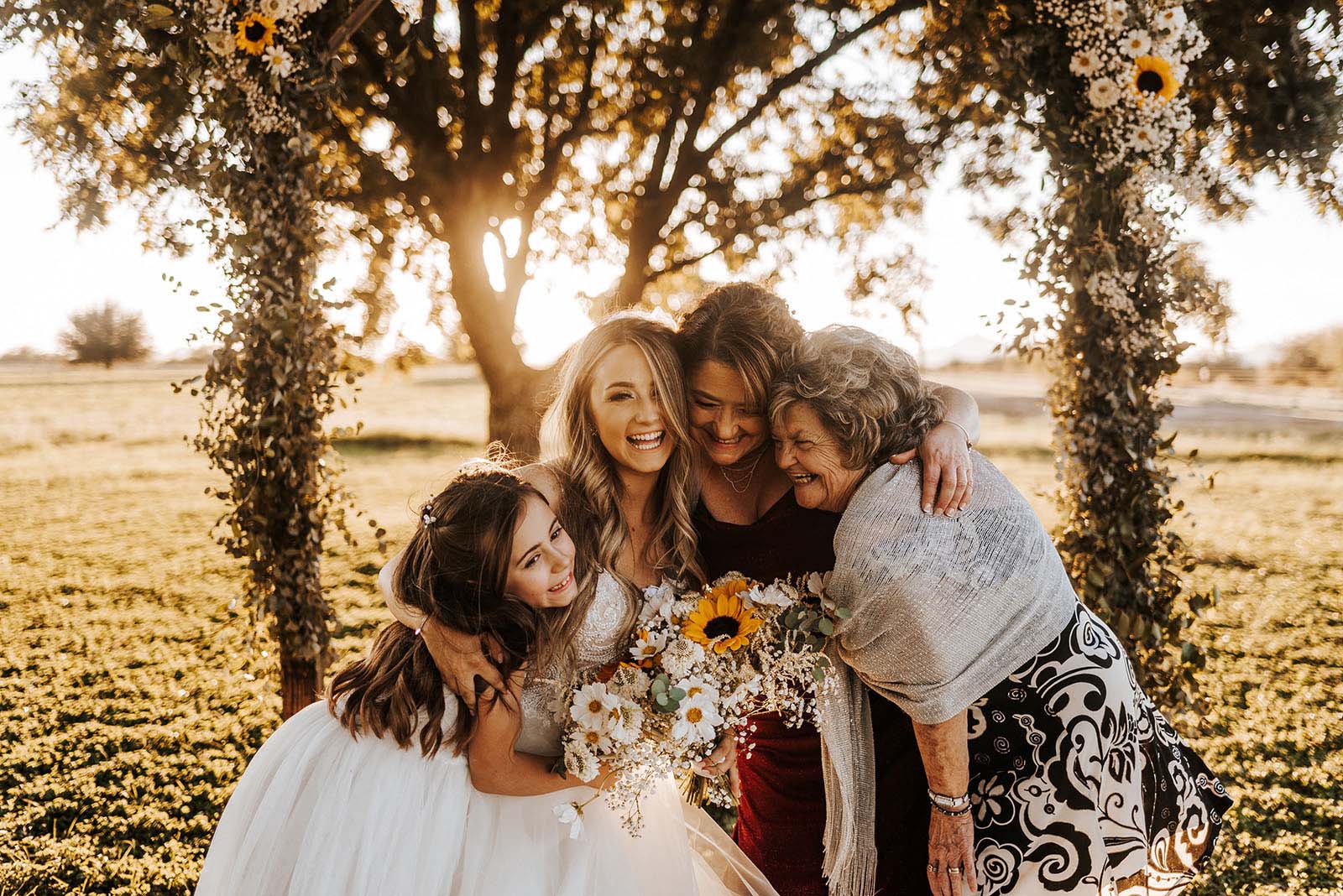 Andrea Obert 2 @andreaobertphoto love in the time of covid Bride and her family hug during Covid-19 wedding photos