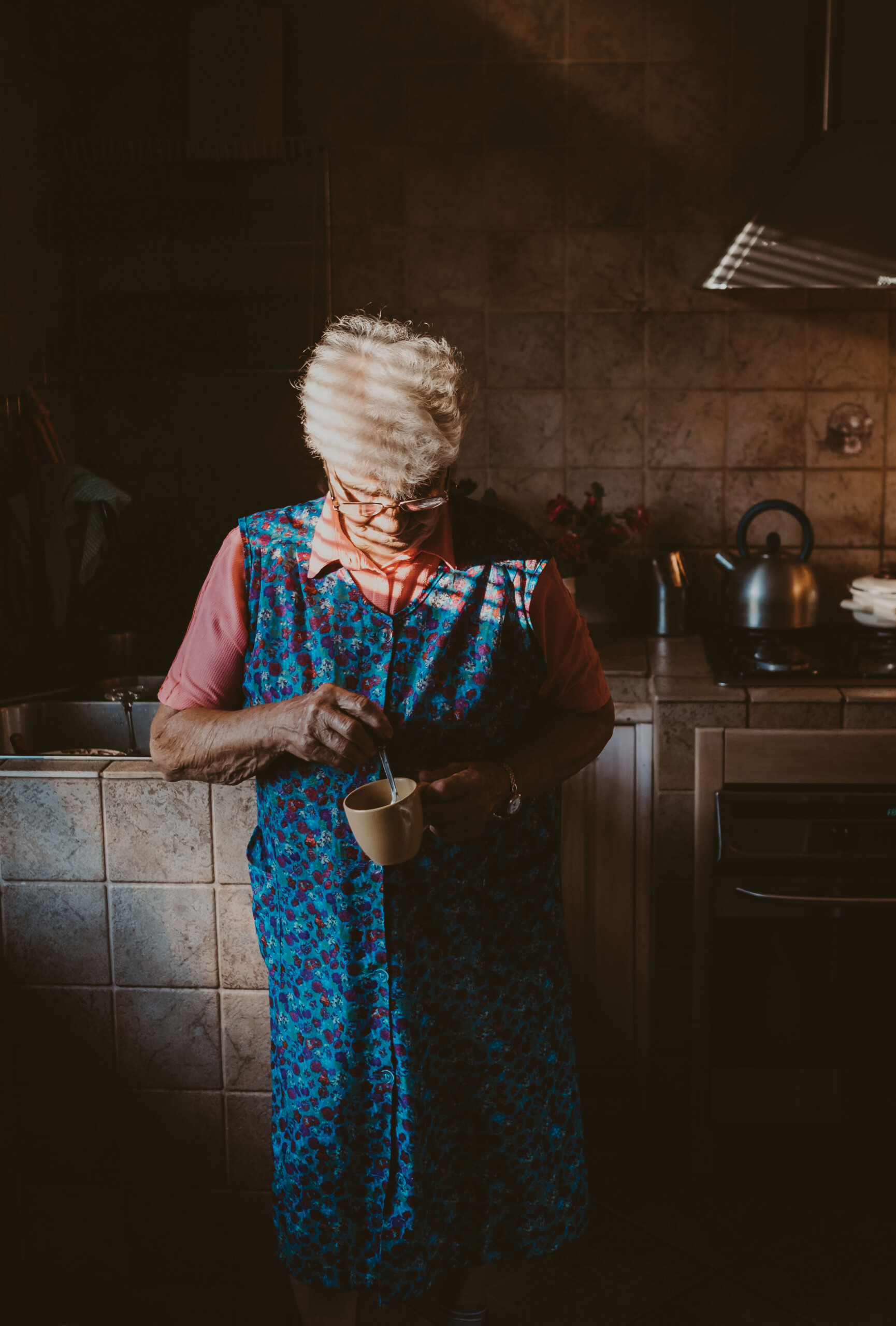 Woman making tea in dramatic light