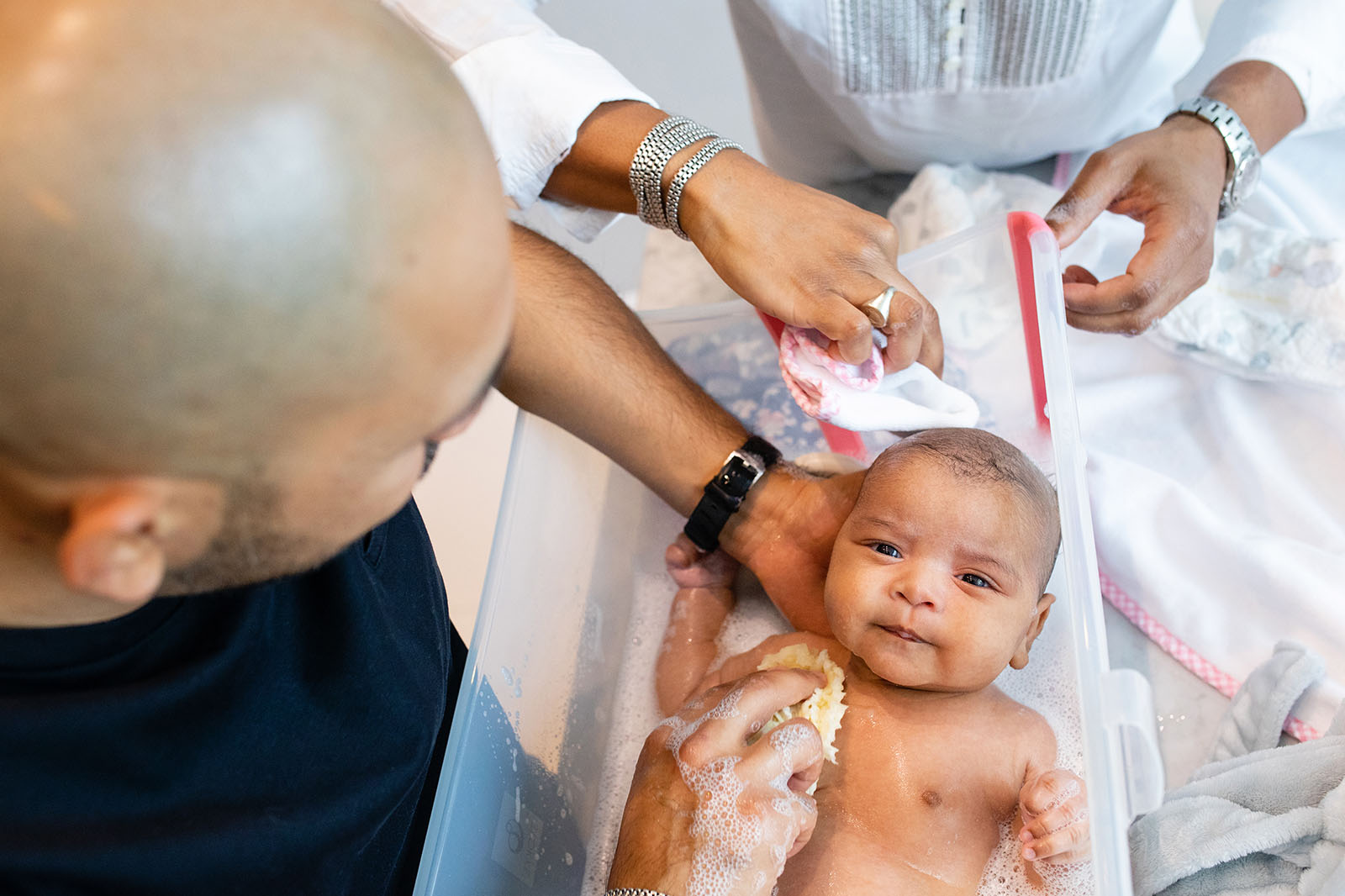 Fathers giving baby a bath