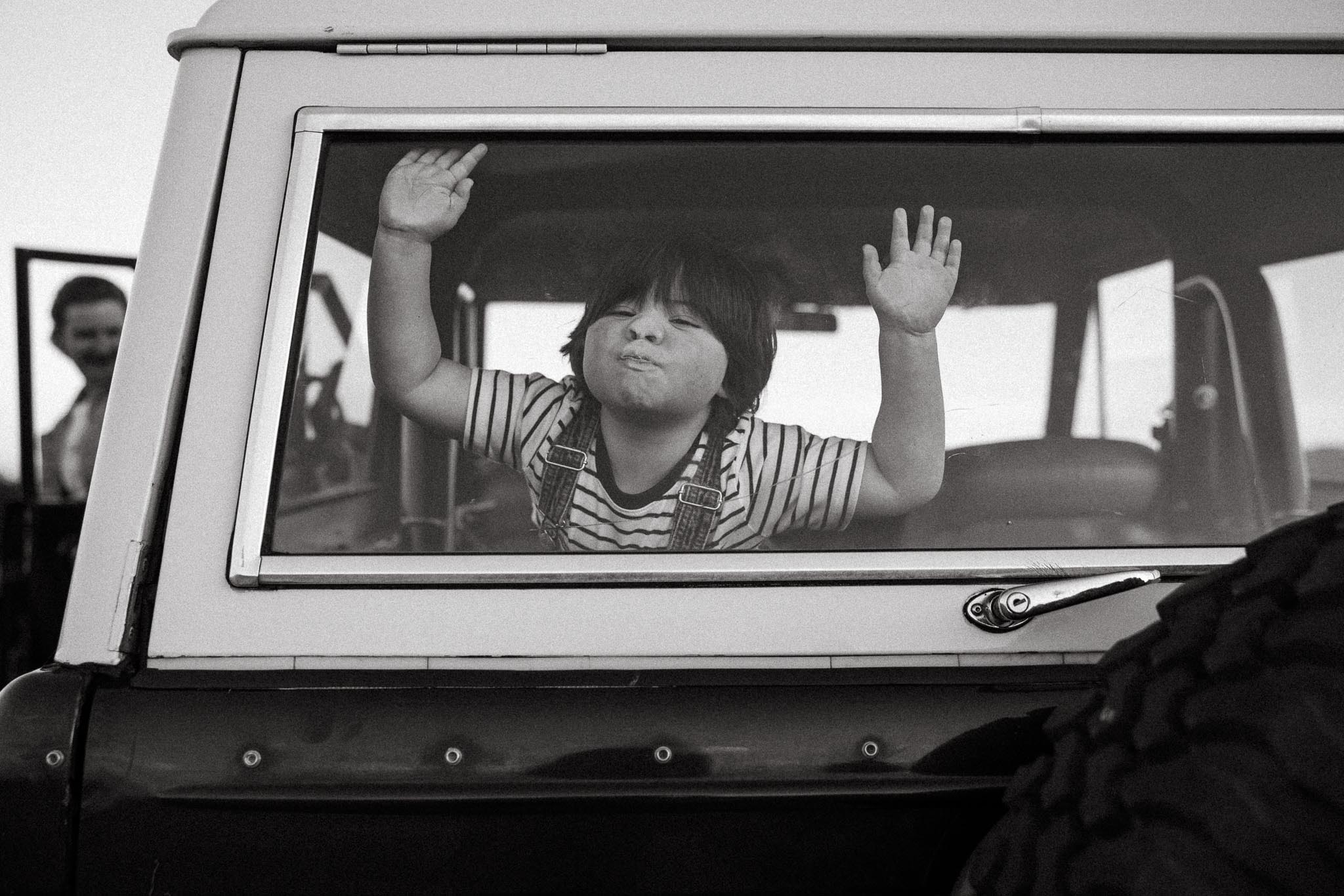 Photo of child with face against car window