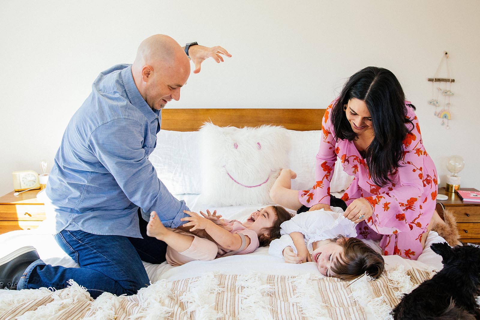 client-feedback-photography A family plays on a bed
