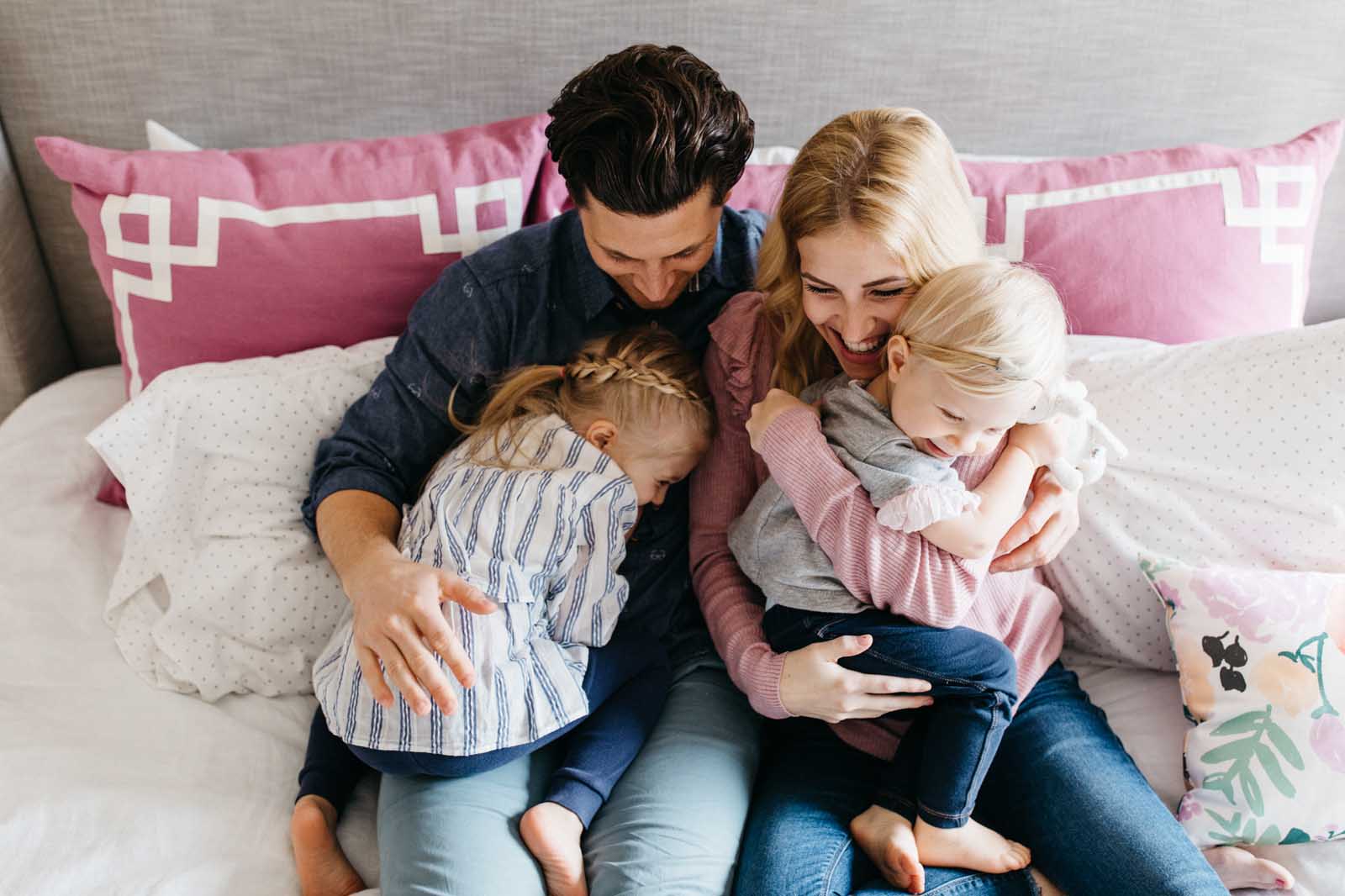 A family snuggles during a day in the life session of photography