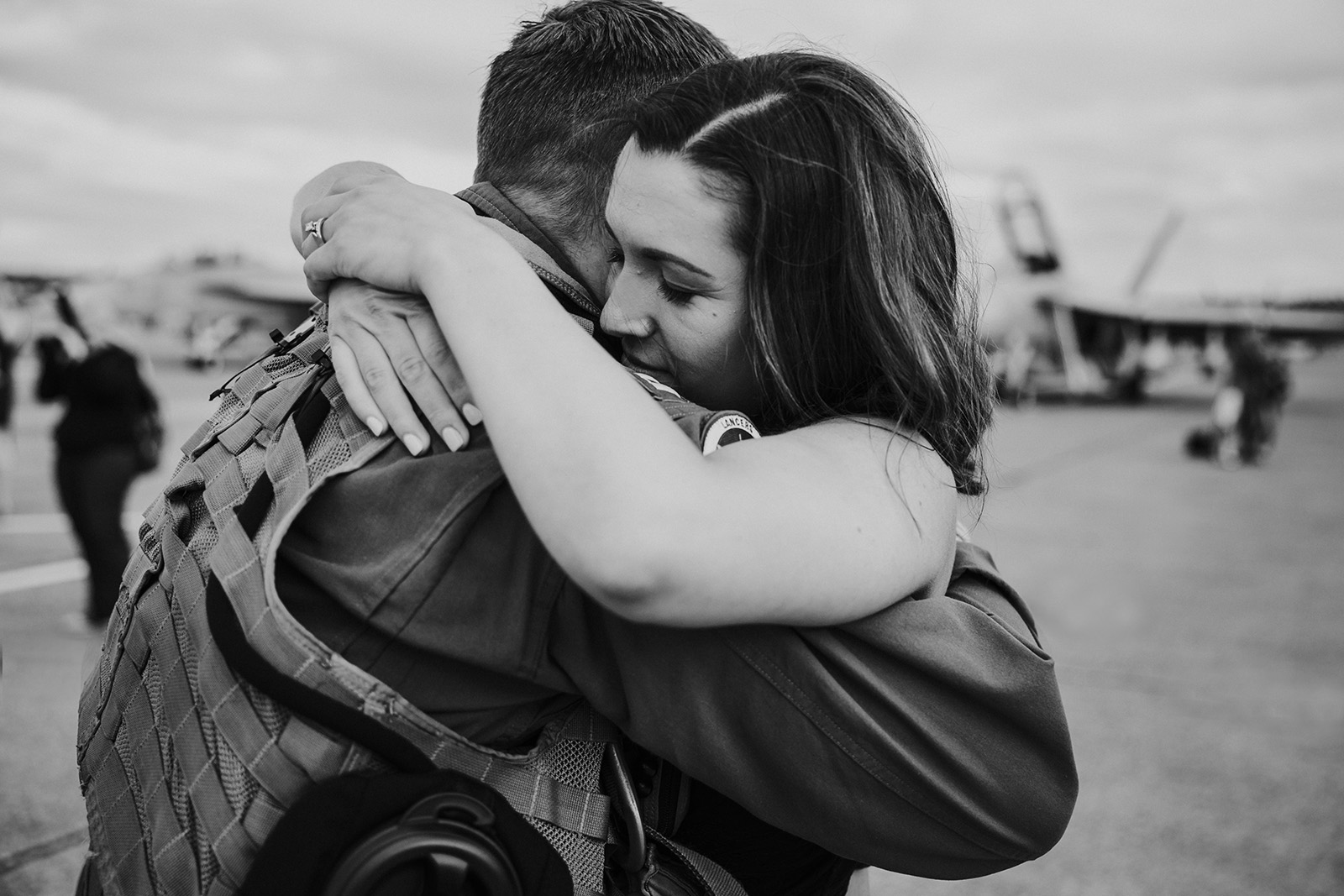 husband-and-wife-embrace-during-homecoming-reunion-by-Kara-Chappell Photographing a military homecoming - tips for photographers