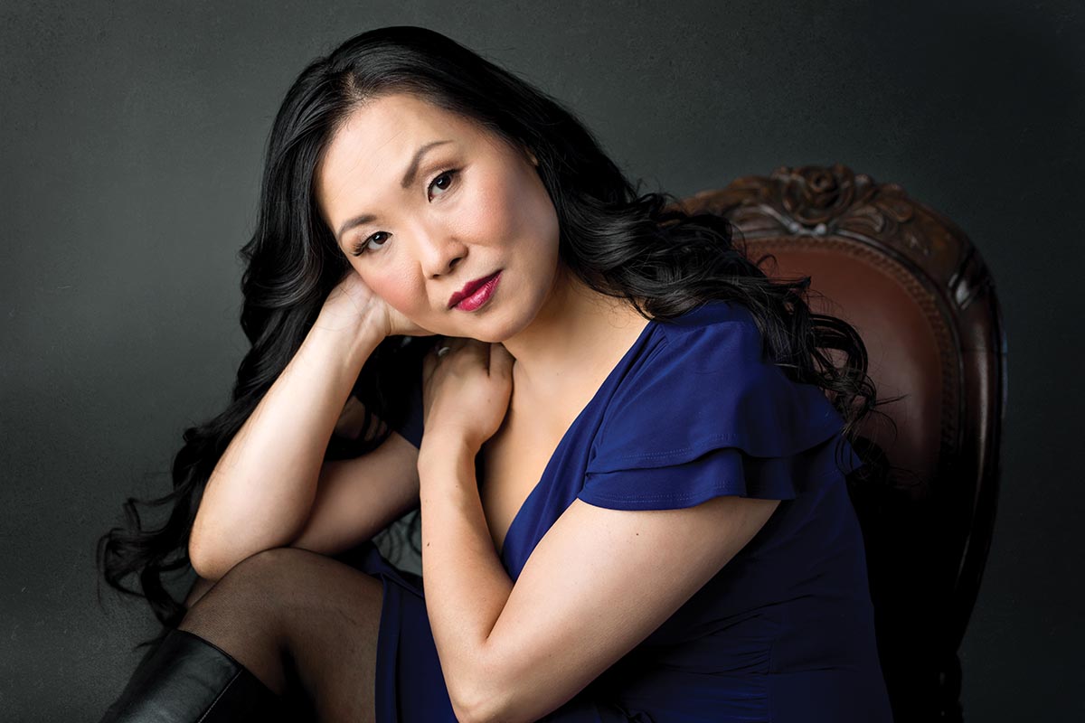 Dramatic headshot of a woman in a chair