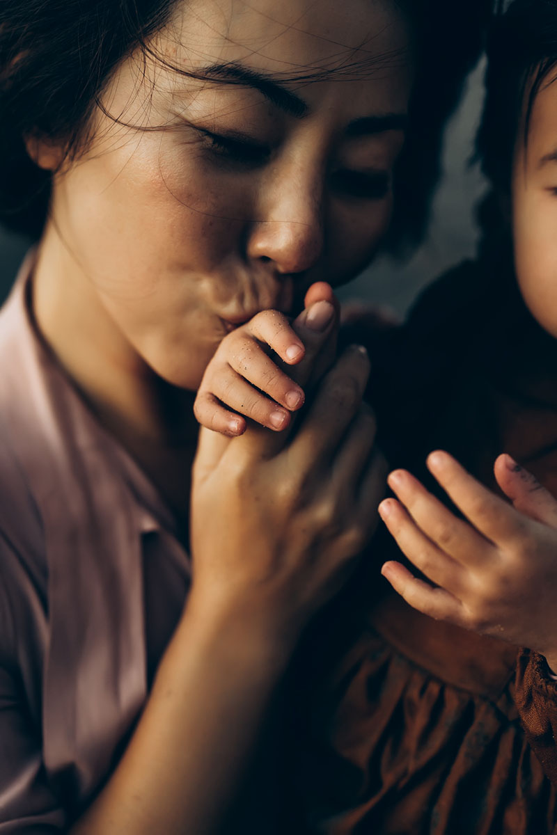 Photo of mom kissing toddler's hands