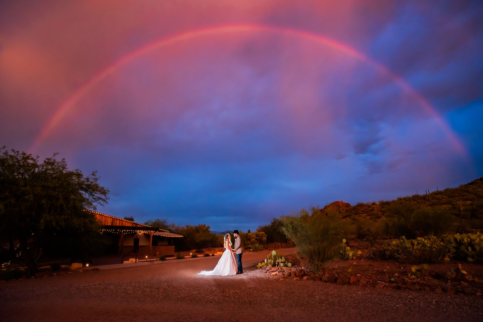 Lupita Ramirez @solaris_tucson Solaris_Photography_Tucson love in the time of covid Bride and groom under a rainbow at night during Covid wedding photos
