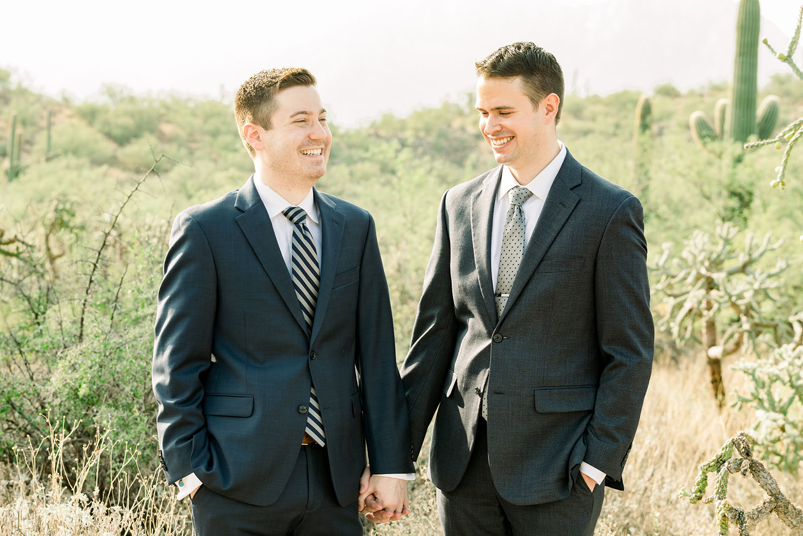 Maria Gawne 2 @thegawnes love in the time of covid Two men hold hands in the dessert, Covid wedding photos