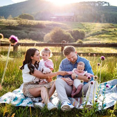 Environmental portrait of a family with mountains in the background
