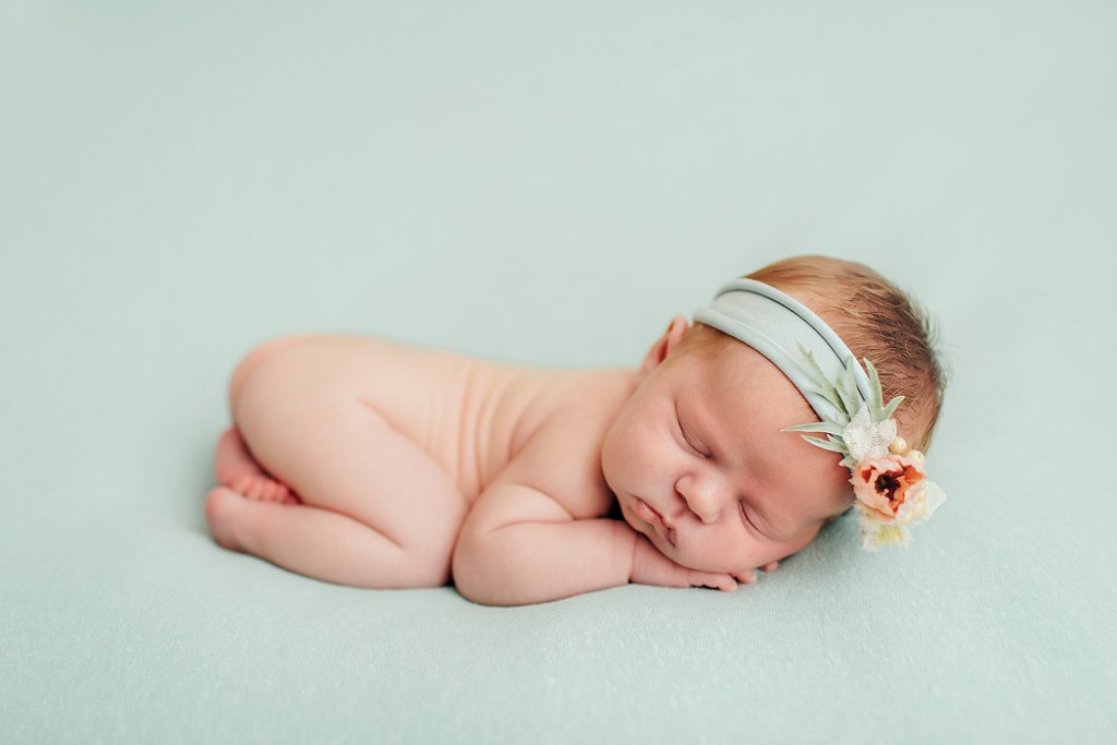 newborn photo on a blue blanket by Winnie Bruce