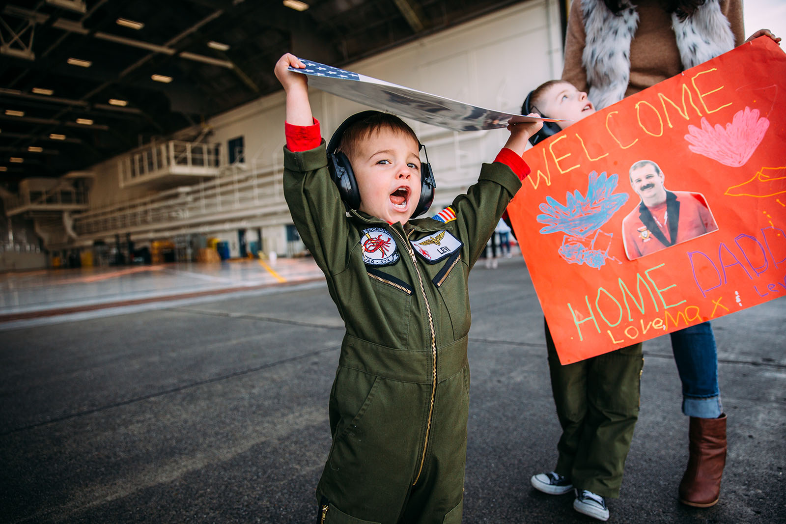 photo-of-boy-cheering-during-military-homecoming-by-Kara-Chappell A little boy waits for his father at a military homecoming