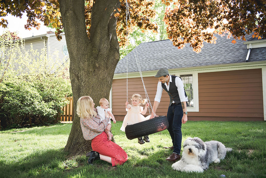 photo of family and dog playing under a tree by Erin Schmidt