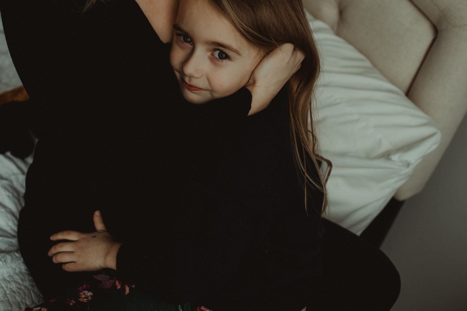 Mom hugging child. Finding balance with photography and motherhood