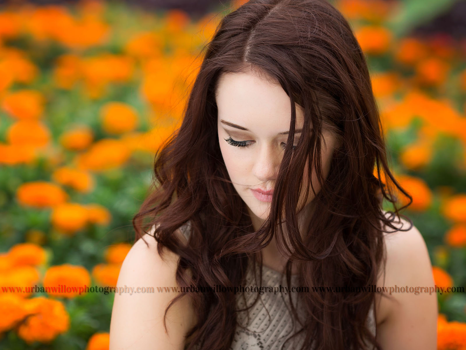 portrait of senior girl in a field of orange flowers by Lori Vieth