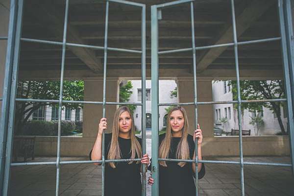 Twin girls look out a window