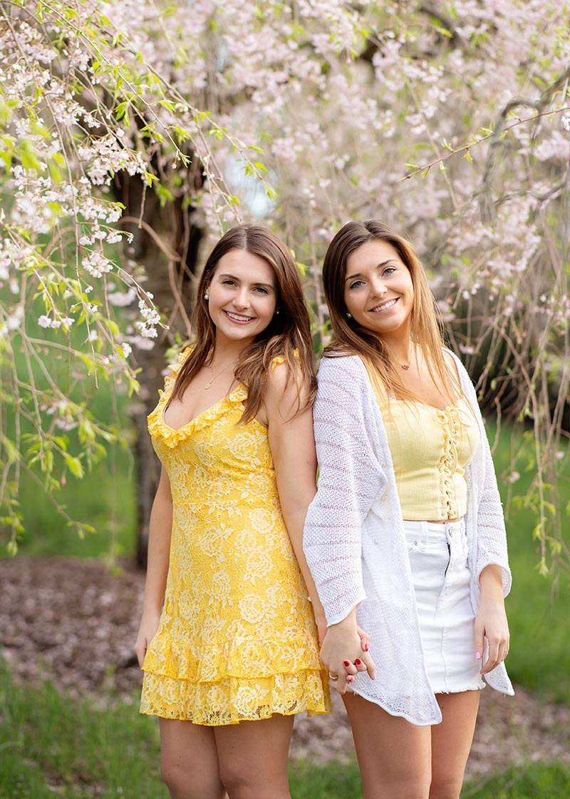 Twin senior girls at a photo session in a park