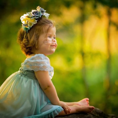 Little girl in styled fairy photo shoot with backlighting