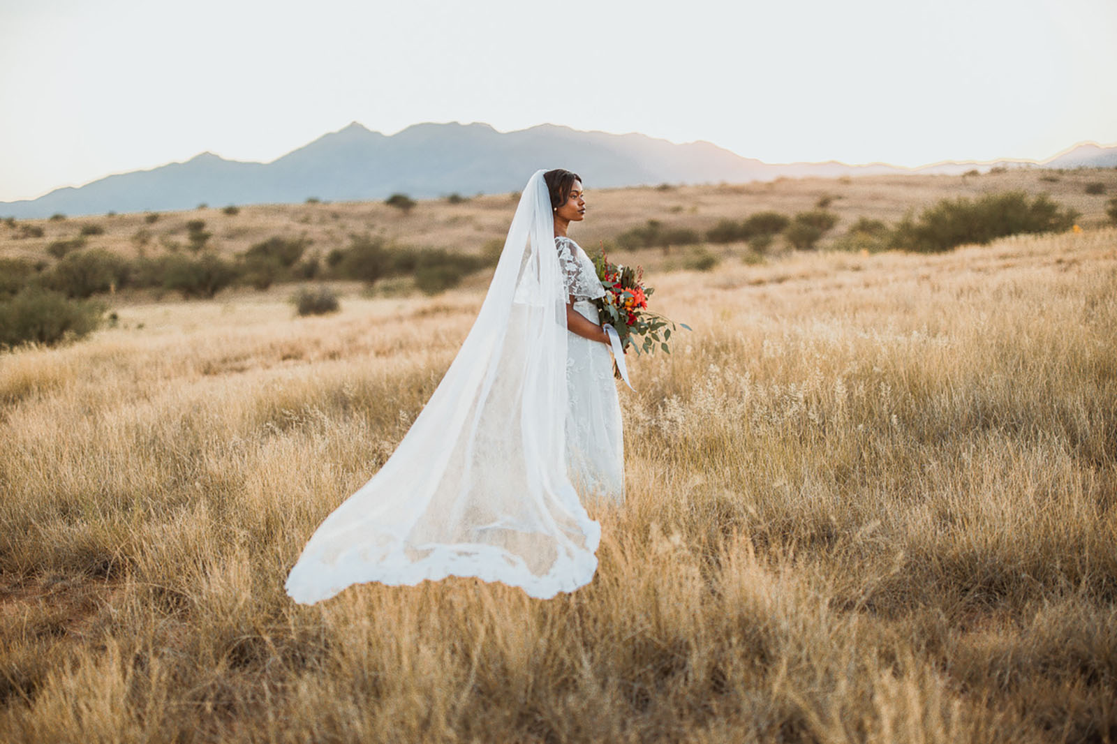 taylor nations @taylornations_photography love in the time of covid A bride stands in field during Covid wedding photos