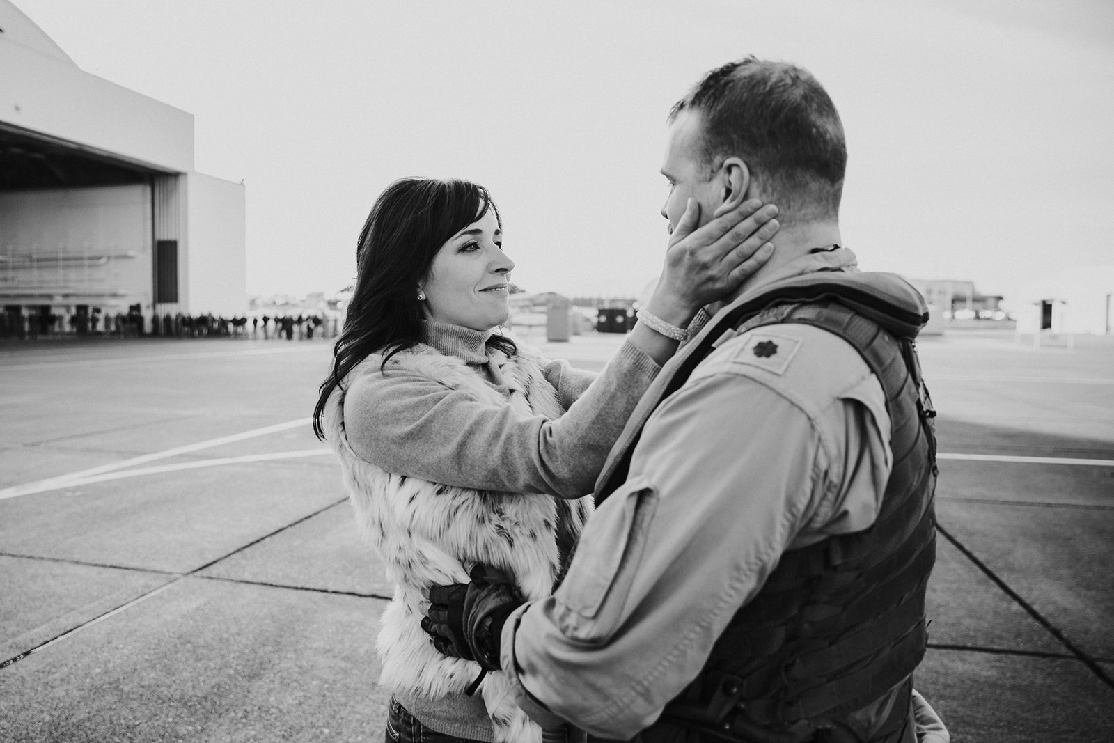 woman-holds-mans-face-after-homecoming-reunion-by-Kara-Chappell